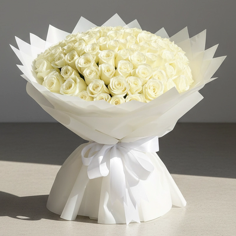 Elegant 100 White Roses Bouquet wrapped in luxury white paper, available for online delivery at Online Flower Shop UAE