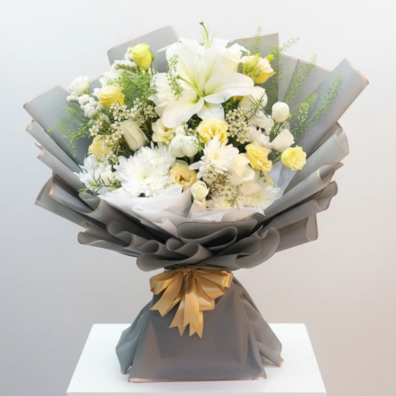 Elegant white and peach mixed bouquet featuring a prominent white Lily, yellow Roses, and Chrysanthemums, wrapped in stylish gray paper with a gold ribbon. Perfect as a Get Well Soon flower gift in the UAE.